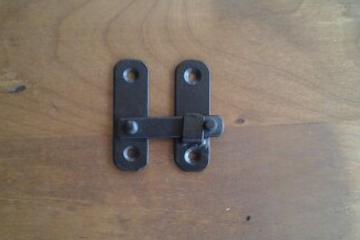 A Black Small Clip Door Grills and Speak Easy Hardware