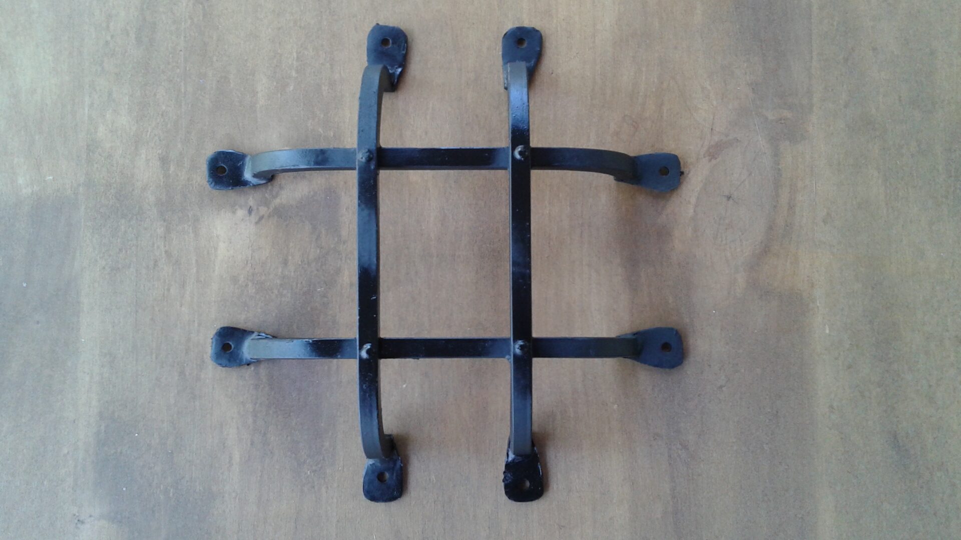 Black metal wall mount with screws.